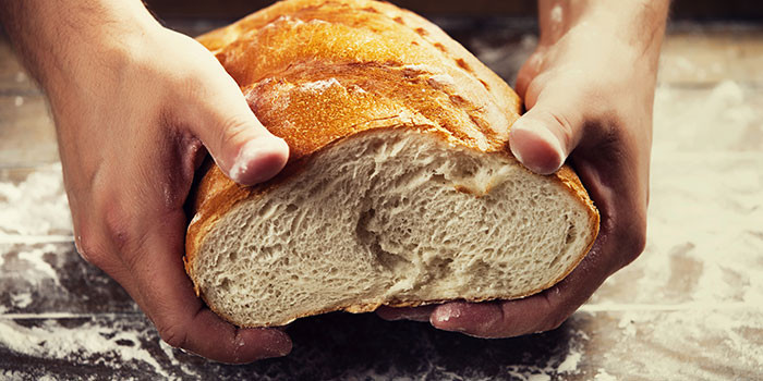 Hands breaking bread