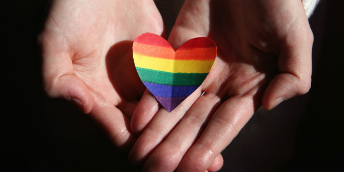 Hands Holding Rainbow Heart